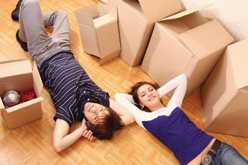 Careful lifting and moving of furniture with protective equipment